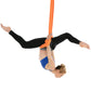 Orange aerial yoga hammock set with elastic ropes, person upside-down stretching pose