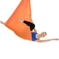 Orange aerial yoga hammock set with elastic ropes, person reclined in yoga pose
