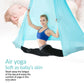 Light blue aerial yoga hammock set with elastic ropes, person stretching in hammock
