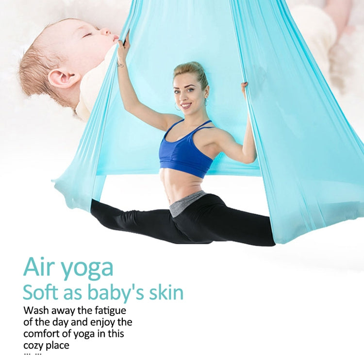 Light blue aerial yoga hammock set with elastic ropes, person stretching in hammock