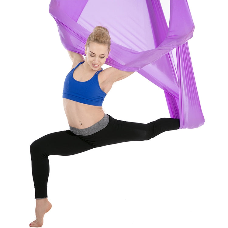 Purple aerial yoga hammock with mesh fabric, person stretching legs