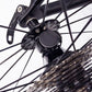 Bicycle wheel speed sensor mounted near the fork, black circular housing