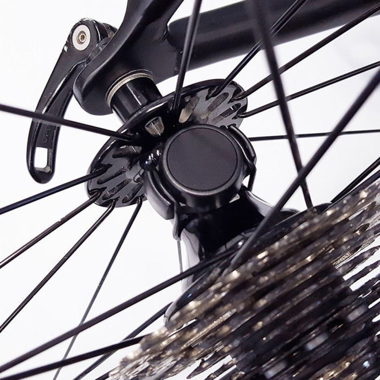 Bicycle wheel speed sensor mounted near the fork, black circular housing