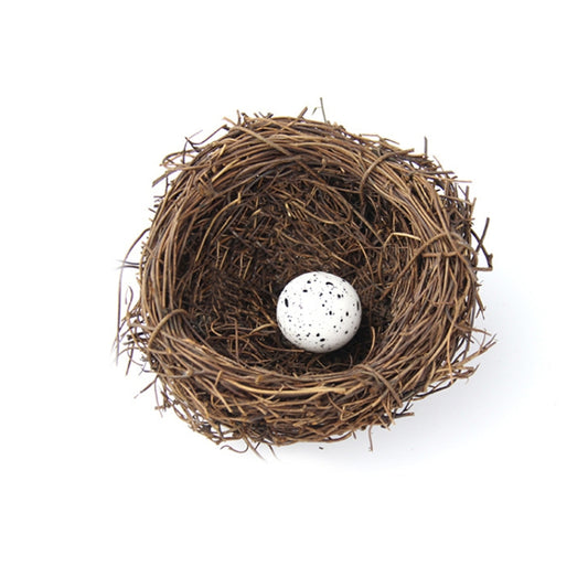 Simulated bird nest decoration with one white speckled egg