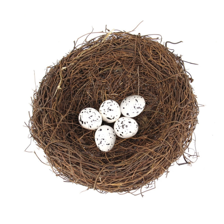 Bird nest decoration featuring a brown twig nest with five speckled white eggs