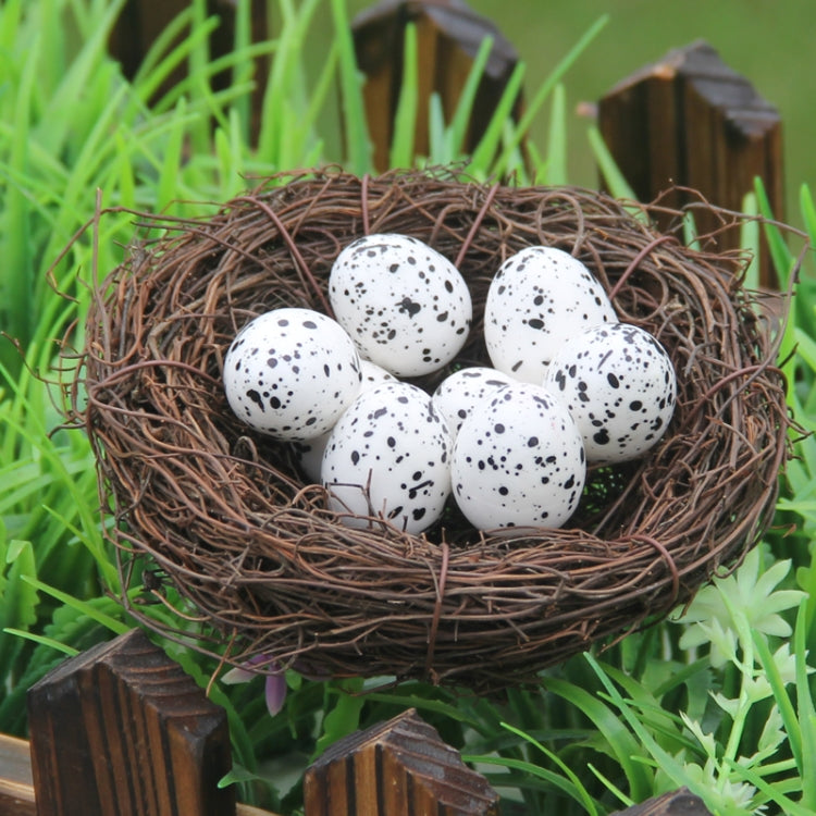 Bird nest decoration close-up with brown twig nest and five speckled white eggs