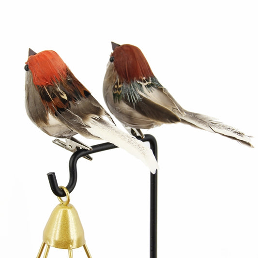 Two mounted foam sparrows with orange-red heads on black stand with gold bell.