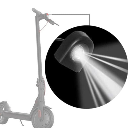 LED scooter headlight with bright white beam, black housing and lens, on scooter