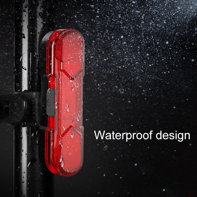 Red LED bicycle taillight with waterproof design, raindrops around the lens