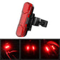 Red LED bicycle taillight close-up with glowing rear light and textured lens