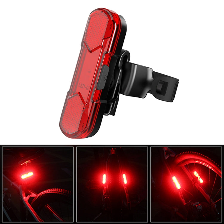 Red LED bicycle taillight close-up with glowing rear light and textured lens