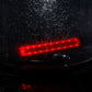 Glowing red bike tail light with rectangular clear housing