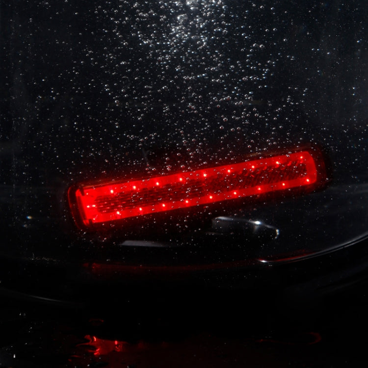 Glowing red bike tail light with rectangular clear housing