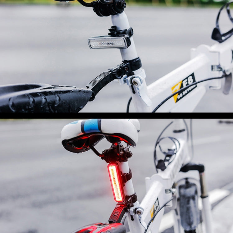 Bike tail light with red glowing lens, mounted on rear seatpost.