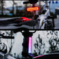 Bike tail light showing red and purple LED modes on seatpost mount.
