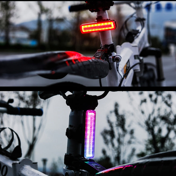 Bike tail light showing red and purple LED modes on seatpost mount.