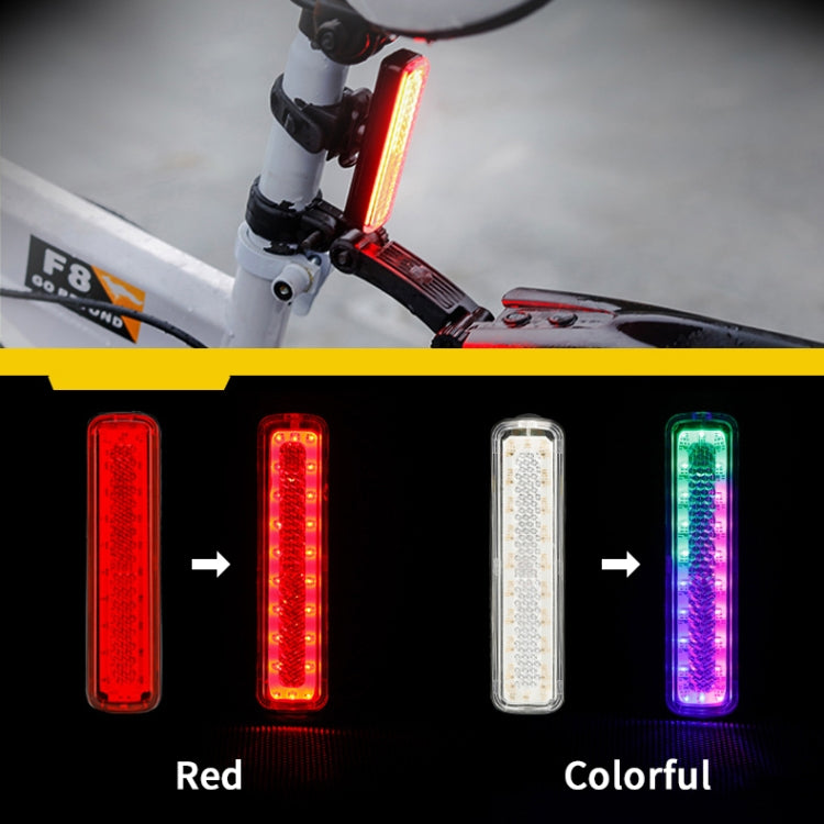 Bike tail light mounted on handlebar, glowing red-orange or colorful mode.