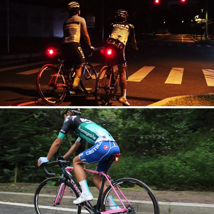 Two bicycles at night with red rear taillights glowing for visibility