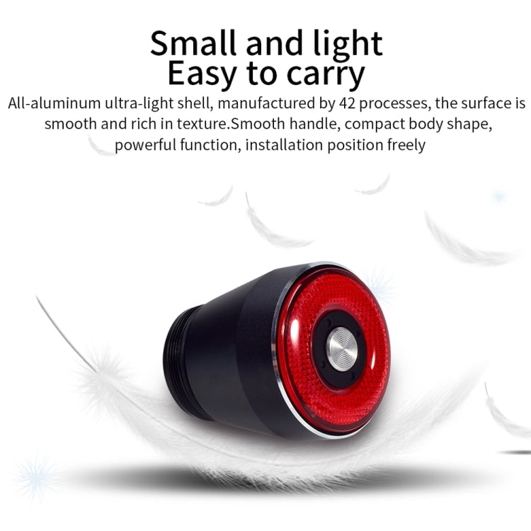 Compact black bicycle rear light with red circular lens