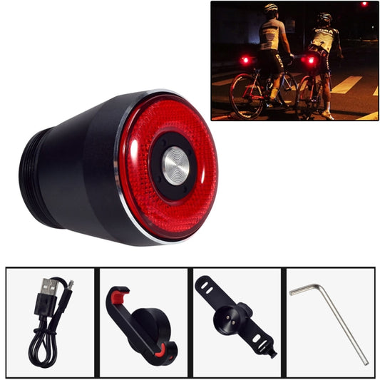 Black bicycle rear light with red circular lens, compact cylindrical body