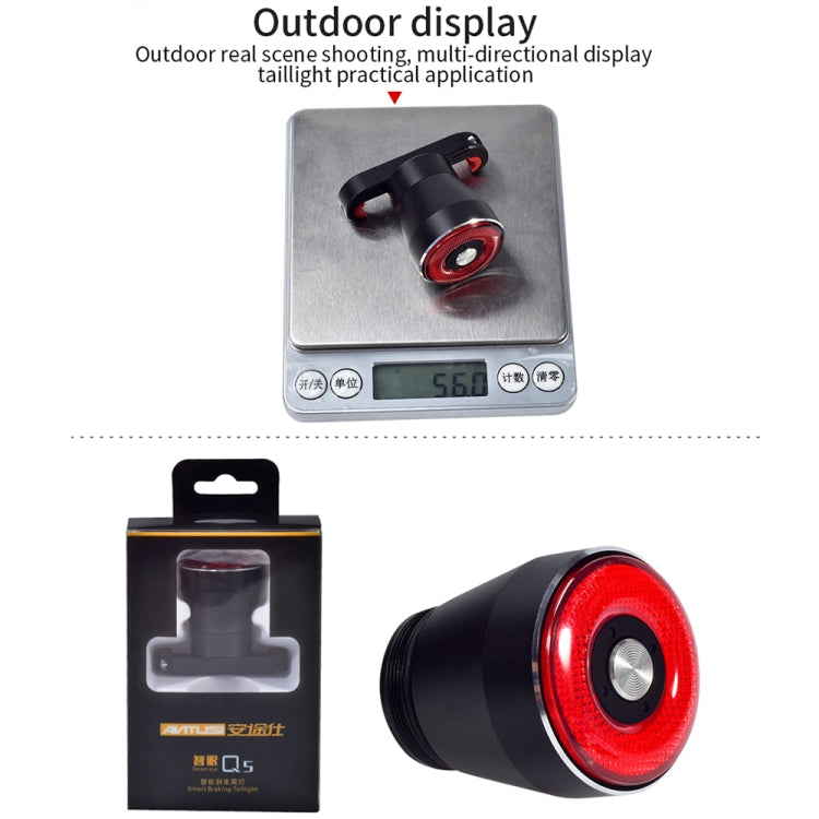 Black and red bicycle rear light resting on a digital scale