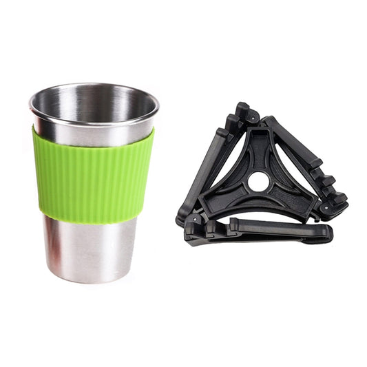 Camping cup and foldable pot stand with green sleeve and black metal frame