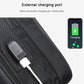 Black textured chest bag with external USB charging port and cable attachment