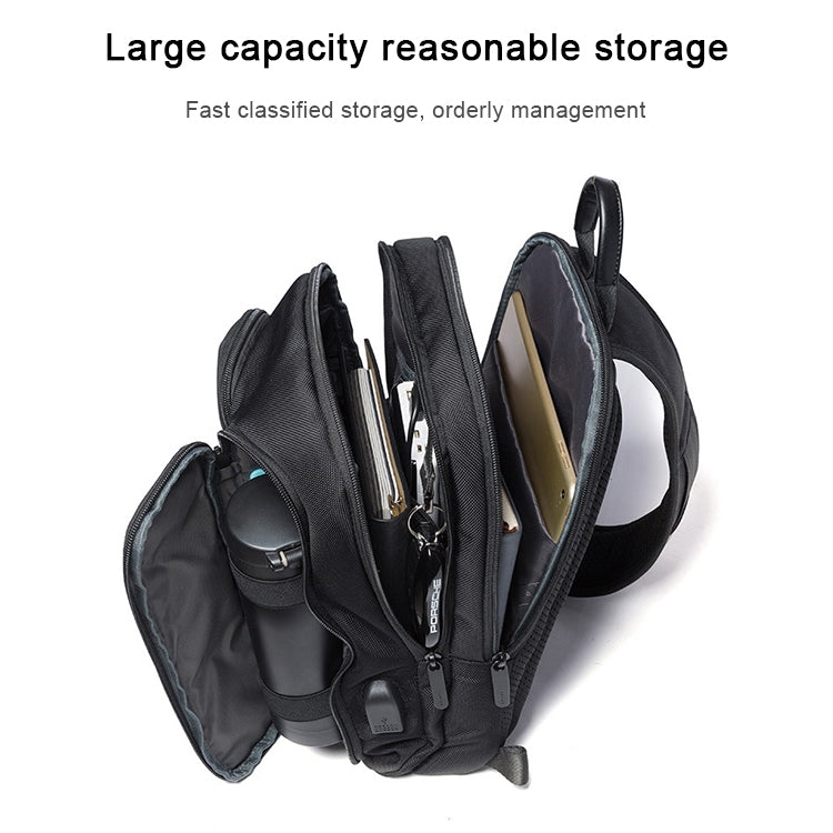 Black chest bag shown open with multiple compartments and zipper organizers