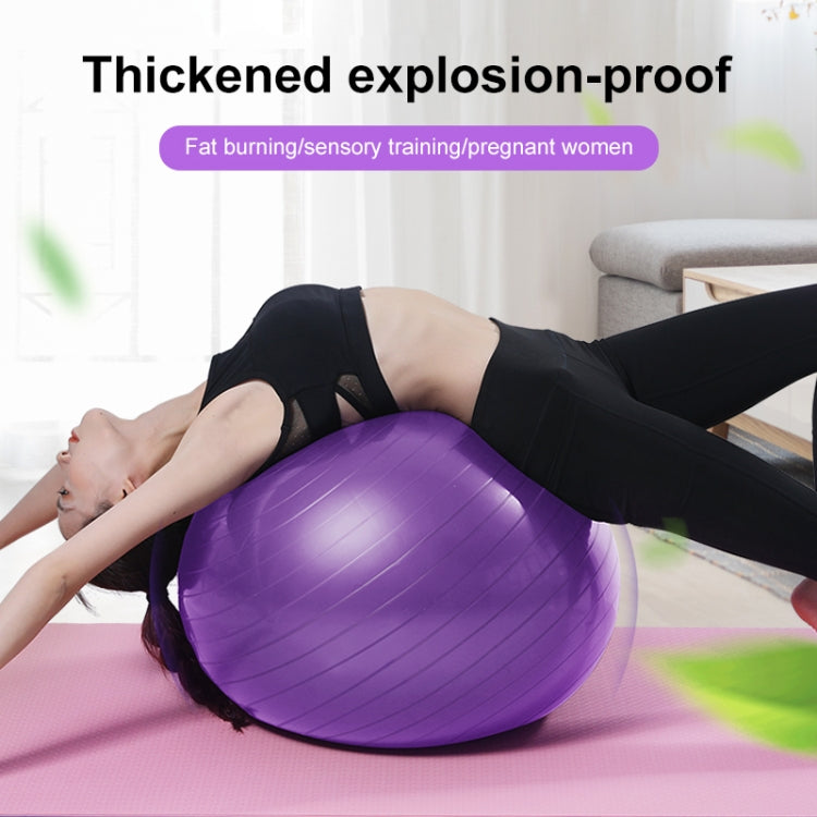 Purple thickened anti-burst fitness yoga ball on a mat for leg exercises