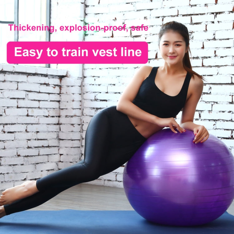 Purple anti-burst fitness yoga ball used for seated stretching