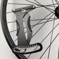 Bicycle spoke tension meter tool mounted on a wheel rim with gauge scale