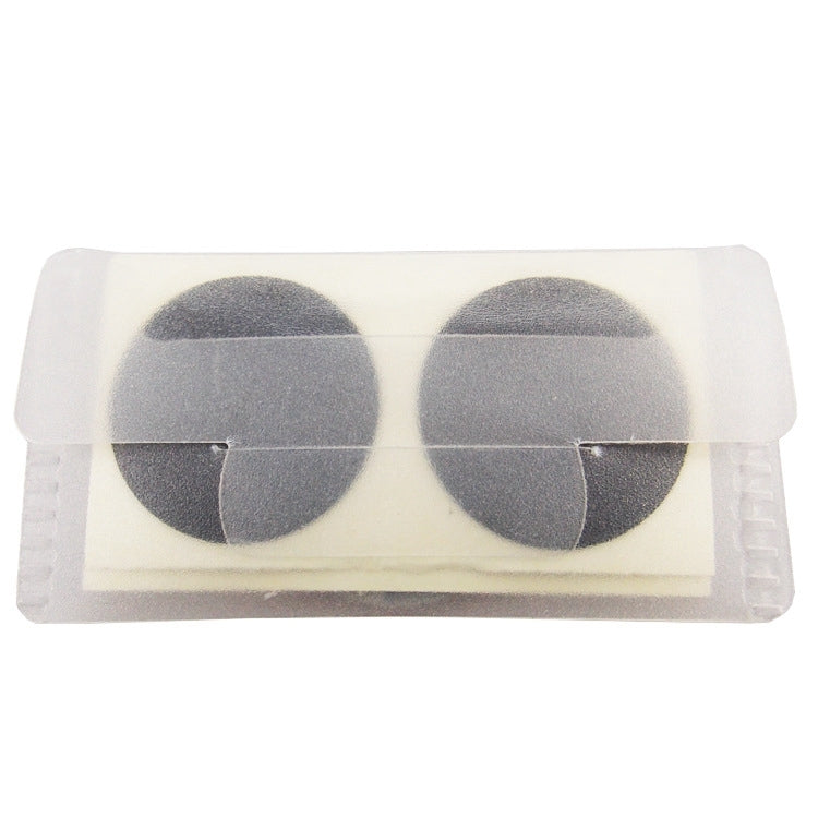 Glue-free bicycle tire patch pair, two dark circular patches inside clear plastic