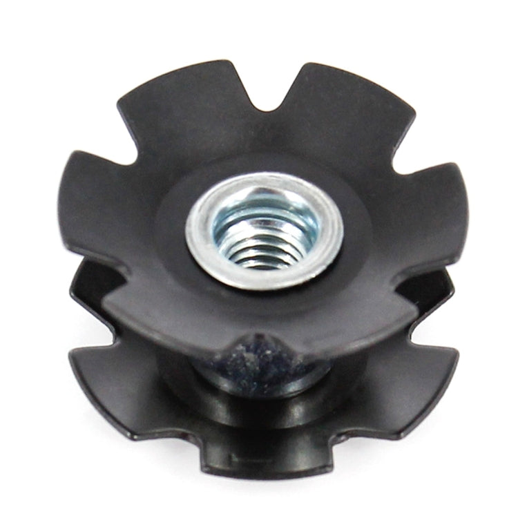 Black star-shaped bike headset nut with metal threaded insert