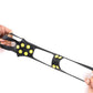 Hands stretching black non-slip ice traction shoe cover with yellow studs