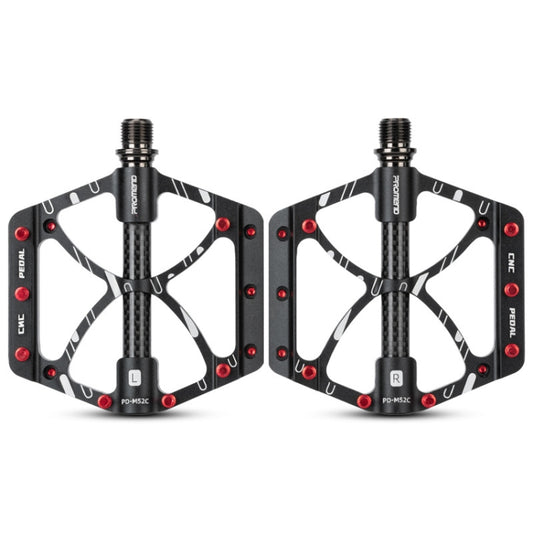 Pair of black bicycle bearing pedals with carbon fiber-look grip and red reflectors