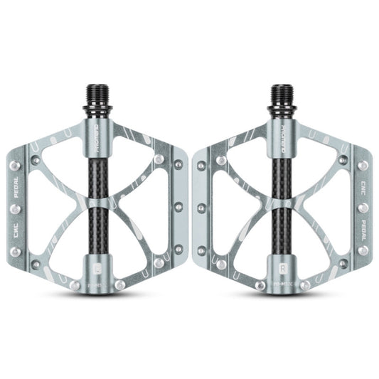 Pair of titanium-gray bicycle bearing pedals with carbon fiber-look grip and platform
