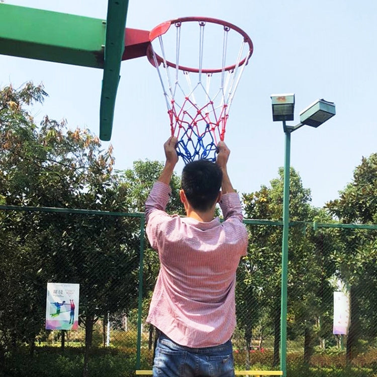 Basketball hoop net made of white, red, and blue rope hanging from rim