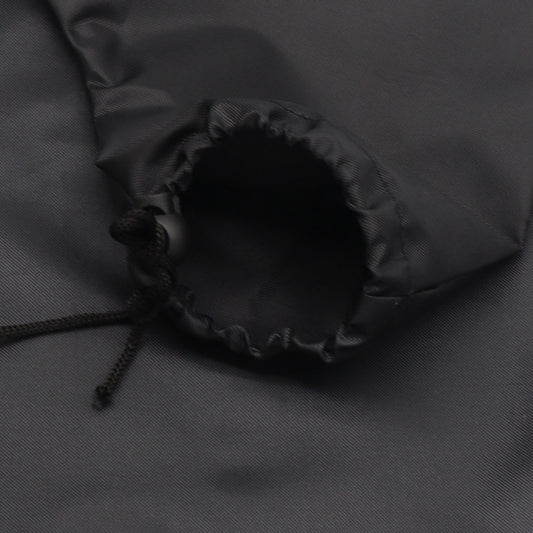 Close-up of black vacuum bag valve port with drawstring cords