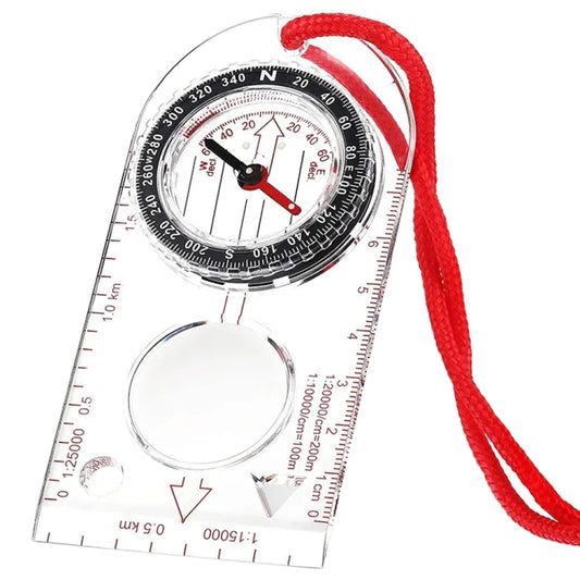 Hiking compass and clear measuring ruler with red cord, angled view