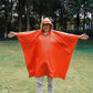 Orange hooded rain poncho worn, wide cape-style sleeves