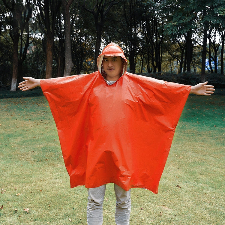 Orange hooded rain poncho worn, wide cape-style sleeves