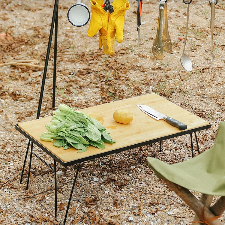 Outdoor folding bamboo desk on gravel with vegetables on the tabletop