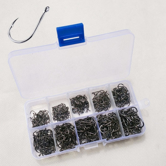 Clear tackle box with blue latch holding assorted barbed fishing hooks in compartments