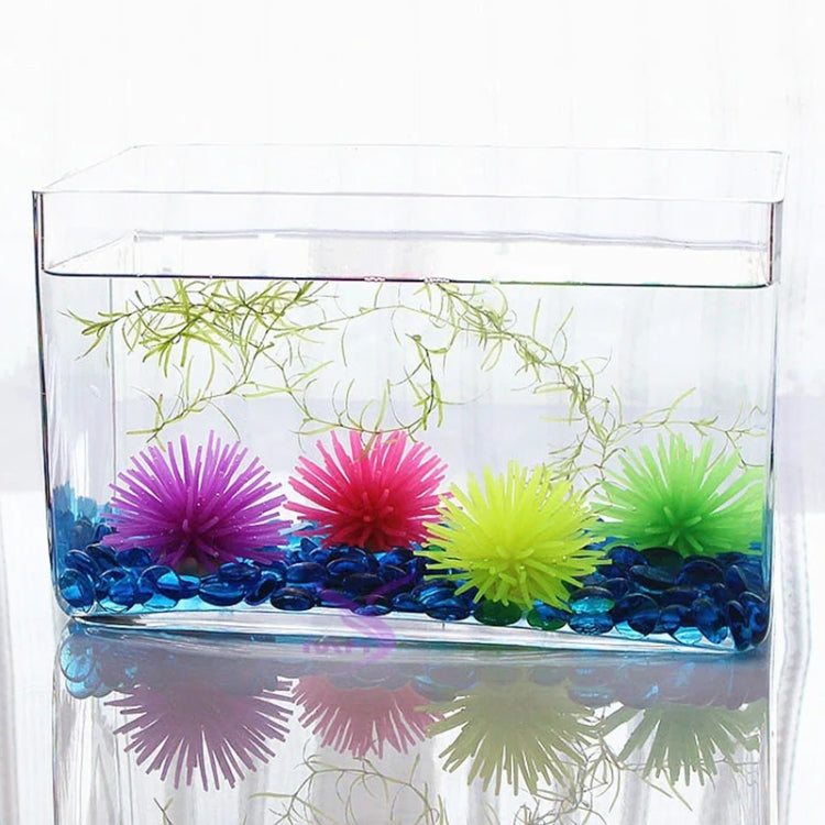Colorful spiky sea urchin ball coral decorations inside a clear aquarium tank