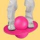 Pink inflatable balance jumping ball underfoot with rounded base pedal