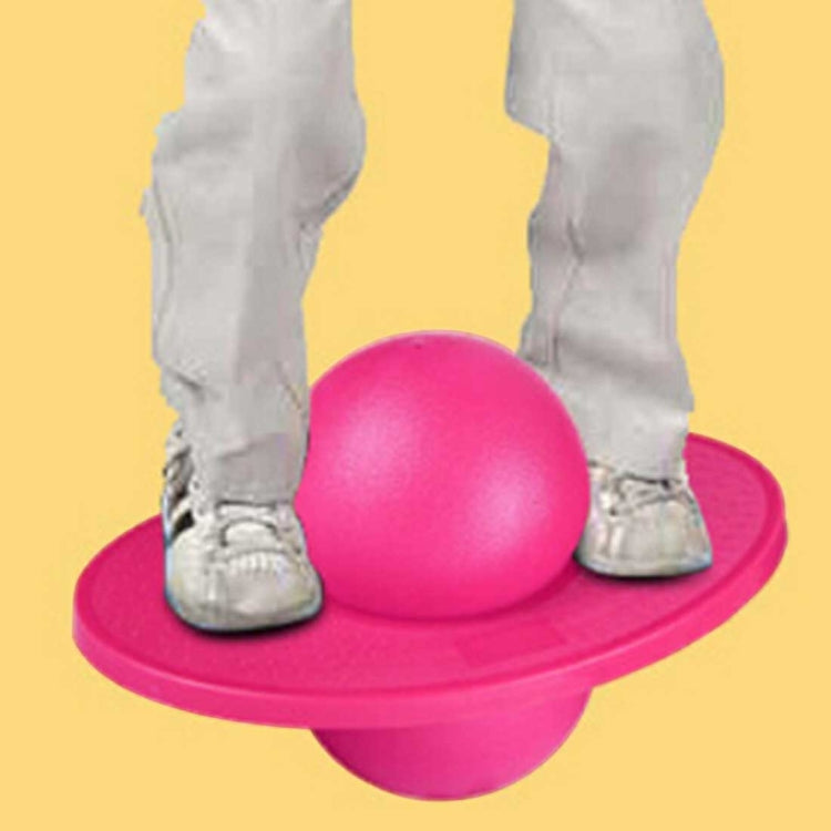 Pink inflatable balance jumping ball underfoot with rounded base pedal