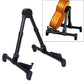 Folding vertical instrument stand holding acoustic violin, black cradle with orange instrument
