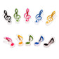 Set of 10 music note shaped spring page clips in mixed colors, clear plastic frames
