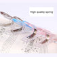 Close-up of a music note spring page clip with clear body and blue note accent
