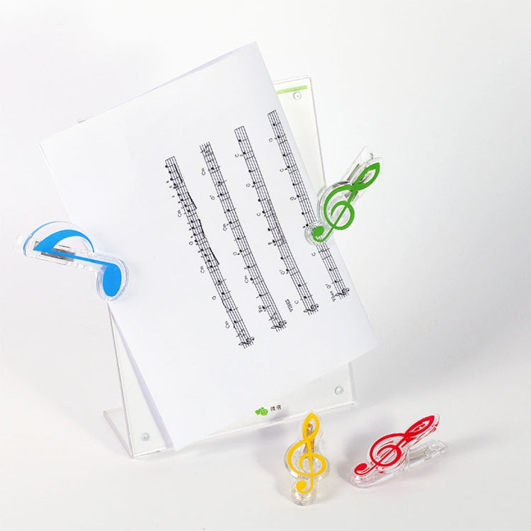 Clear music note spring page clips holding papers, with blue, green, yellow, and red notes